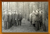 Fred W. Besley and group of men attending a forestry lecture in the field