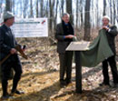 Francis Zumbrun looks on while John Garrett and Kirk P. Rodgers unveil the Centennial Plaque at the Garrett-Potomac State Forest