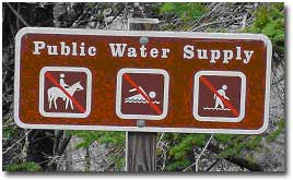 Sign showing that the water behind the sign is part of the public water system