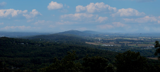 view from an overlook, you can literally see for miles, sky, mountains, farms and forests