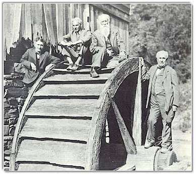 On an ancient waterwheel in West Virginia in 1918, the Four Vagabonds pose for a cameraman. Left to right are Harvey Firestone, Henry Ford, John Burroughs and Thomas A. Edison.