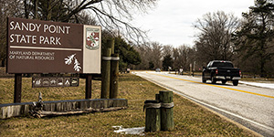 Sandy Point sign with a road