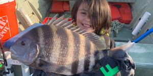 Theodore Post with large sheepshead he caught. Photo courtesy of Courtney Hevner