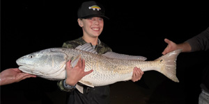 Nathan Anders was fishing at Assateague Island when he caught and released this large red drum, which put a big smile on his face. Photo by James Anders