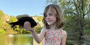 Charlotte Akers caught her first fish, a bluegill, while fishing with her dad and represents the next generation of anglers and conservationists
