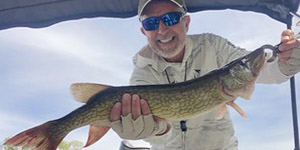 Herb Floyd holds up a chain pickerel before releasing it.
