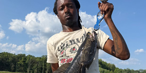 Chaz Wheeler holds up a large Chesapeake Channa he caught near Edgewood, on the Bush River. Photo courtesy of Chaz Wheeler.