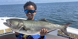 Kid holding Bluefish, photo by Travis Long