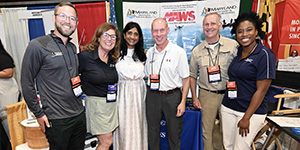 Deputy Secretary Dave Goshorn (center) and Maryland Department of Natural Resources staff welcome Lt. Gov. Aruna Miller to DNR’s display at the Maryland Association of Counties conference in 2025. Maryland DNR photo.