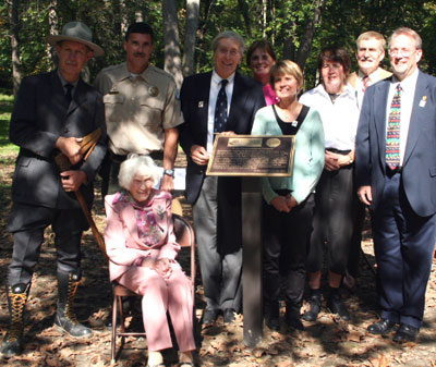 Photograph of DNR staff and Besley family members at the newly dedicated Besley Family Campsite plaque