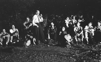 Fred W. Besley telling story at campfire, Maryland Mountain Club, 1941