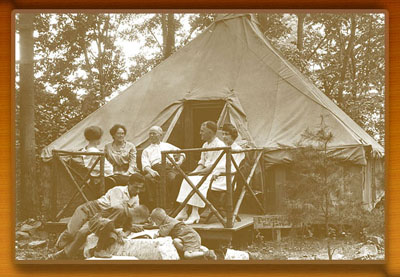 Family enjoying the outdoors from front porch of thier tent