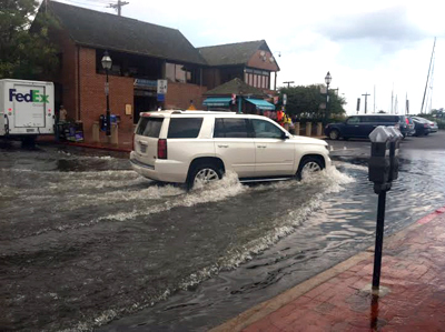 A SUV driving through high water at the Annapolis city dock.