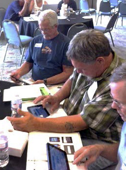 Men sitting at a table during a FACTS training