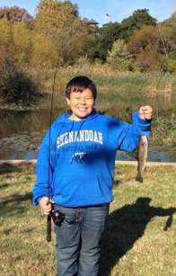 Photo of a kid holding a rainbow trout