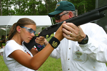 Woman firing a rifle.