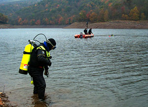 Divers searching a pond
