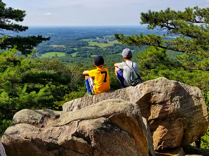 people sitting on a rock by Edward Danielcyzk