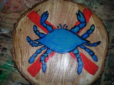 painting of a crab on a piece of tree