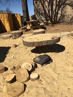 Sandbox with carved tables