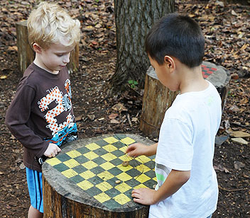 Kids playing checkers at a table