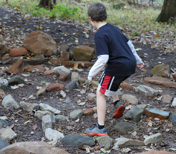 Boy running between rocks