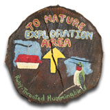 Wood cut with an arrow pointing to a nature exploration area