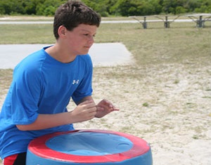 Boy drumming in Natural Play Space