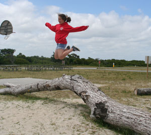 Girl Jumping Over Log