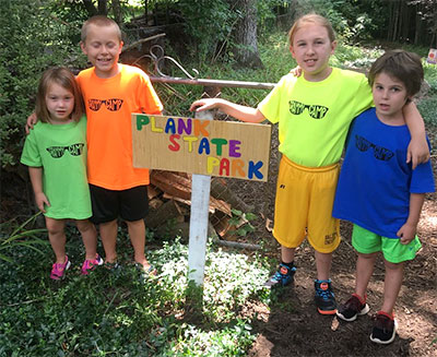 Managers of Plank State Park - Kids by their park sign
