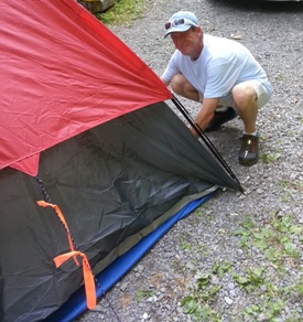 man pitching a tent