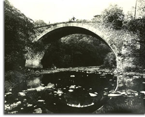 Casselman River Bridge in the early 1900s (bridge arch is reflected in the water). 