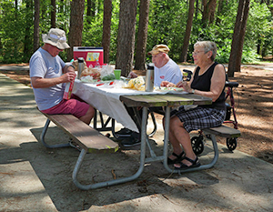 People at picnic table in Tuckahoe State Park
