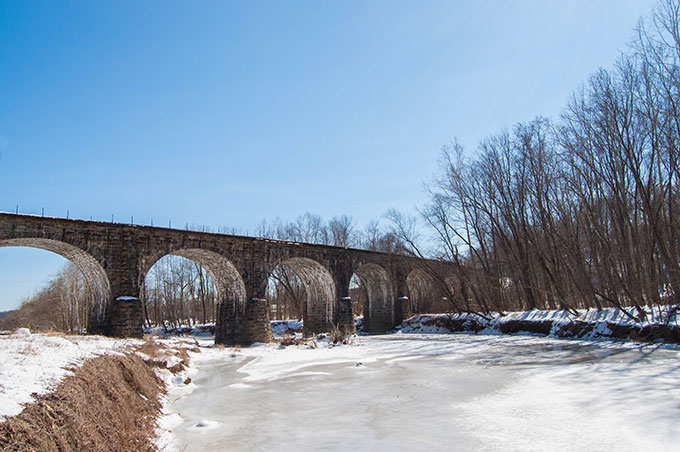 Thomas Viaduct arching over the Patapsco River in winter