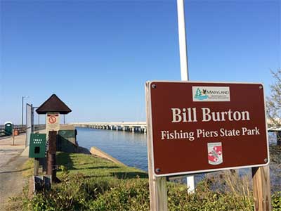 Park sign with fishing pier in background going out into the Choptank River