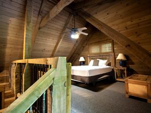 Loft bedroom with queen size bed and vaulted ceiling