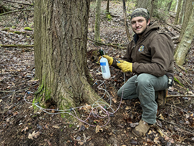 group of Maryland Conservation Corps members surrounded by trees