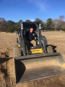 VCC member driving a front end loader