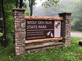Entrance sign for Wolf Den Run State Park