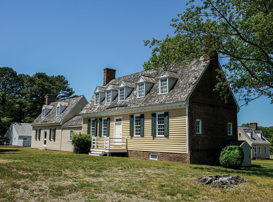 The main house, buttercup yellow with a main section and an extended kitchen. Gabels in the room