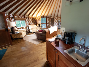 Kitchen area with sink, coffee maker, and fridge