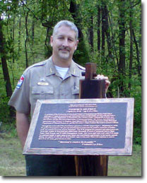 Ranger Patrick Bright, Jr., Manager, Southern Maryland Recreational Complex stands next to the Plaque