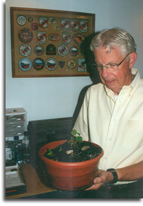 Offutt Johnson holding seedlings from the "Washington Elm" Tree