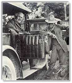 Henry Ford clowns while Thomas Edison beams during a rest stop on a camping trip.