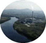 A powerplant located next to a river.