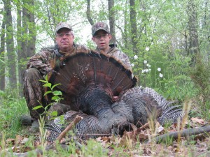 Junior Turkey hunter with mentor and large male harvested turkey