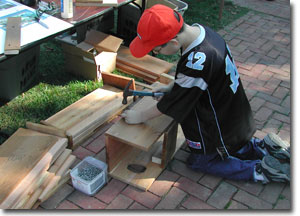 Small boy finishing wood duck box