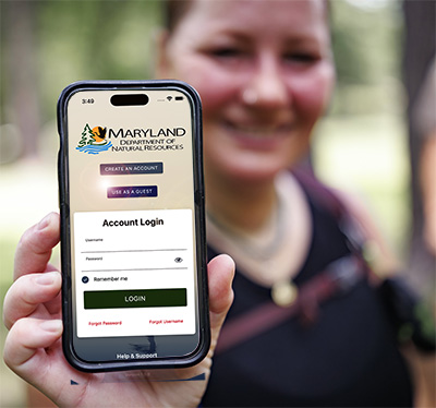 Person holding up a smartphone with DNR's mobile app displayed